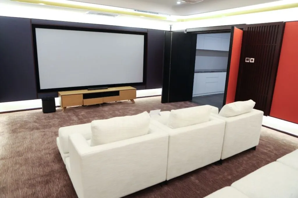 a beautifully transformed basement showcases a cozy home theater, complete with plush seating and ambient lighting, embodying the excitement of a successful renovation project.