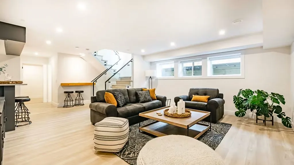 a transformed basement gleams under soft, ambient lighting, showcasing modern finishes and inviting decor, embodying a successful renovation journey.